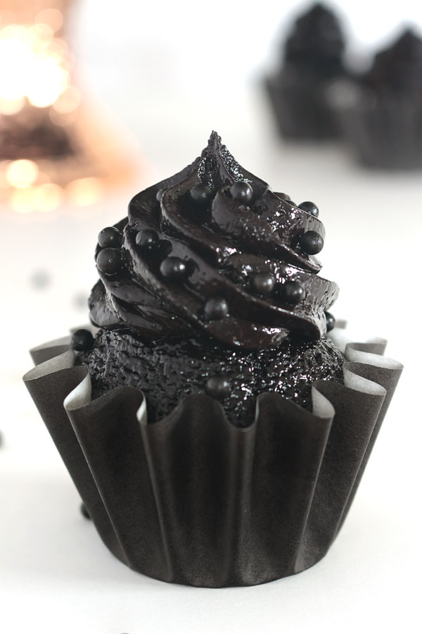The darkest chocolate cupcake recipe ever! These sweet and sexy cupcakes are a crowd pleaser every time!